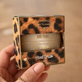 Doosje met panterprint waarin een goudkleurig ronde handcreme verpakt zit met de tekst big hugs