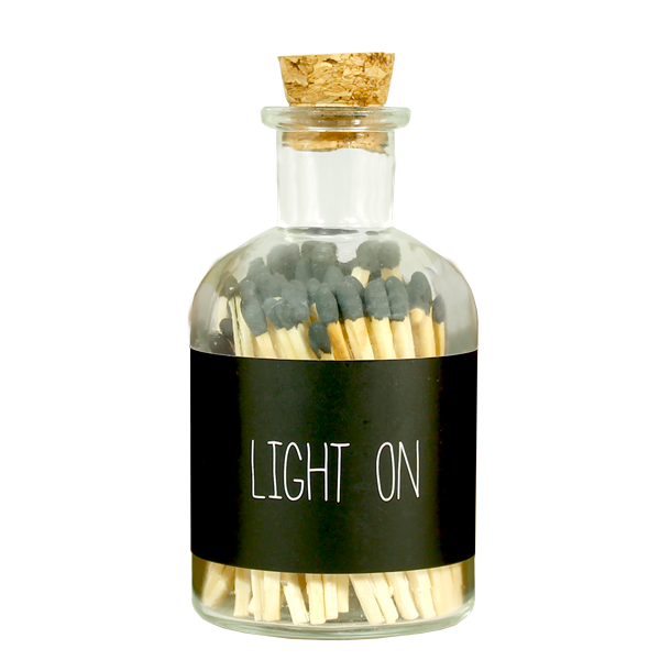 glazen flesje gevuld met lucifers en de tekst light on