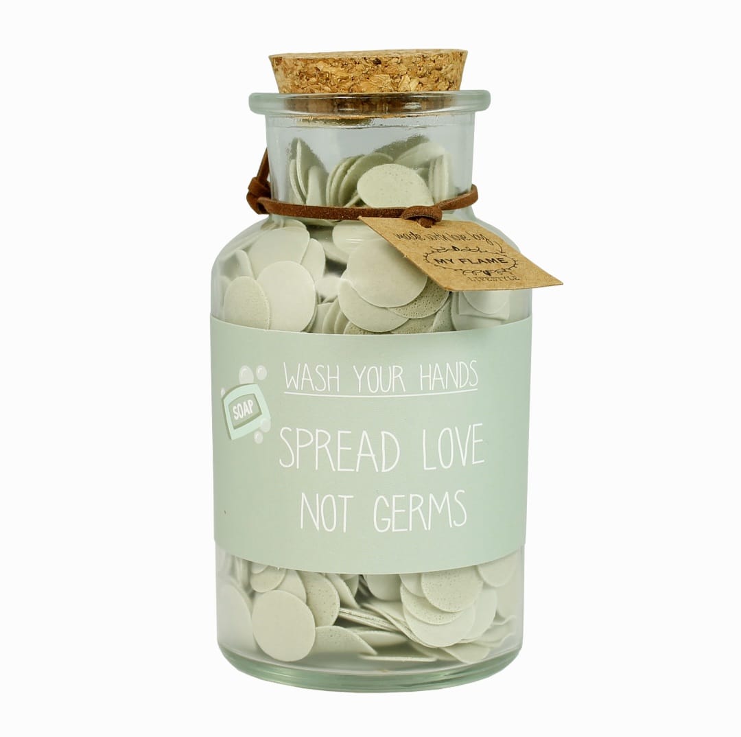 glazen fles met confetti handzeep en de tekst wash your hands, spread love not germs