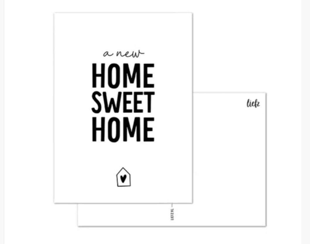 witte wenskaart a new home sweet home geschreven in het zwart
